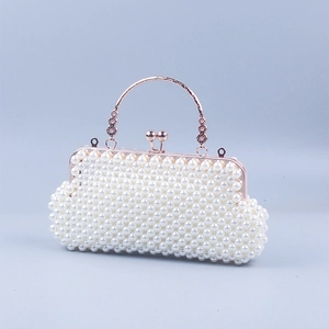 Detail of rose gold handle with floral relief and pearl-encrusted woven shell bag surface