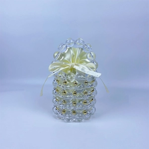 Detailed close-up of handmade beaded handbag with gold accents and cream satin liner