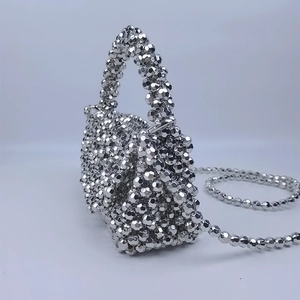 Detailed view of silver beaded mini handbag with metallic multi-faceted bead texture