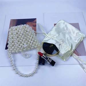 Detailed shot of handmade pearl beaded mini bag with pearls and stylish accessories