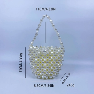 Detail view of ivory handmade pearl bucket bag with dimensions 11x8.5x4cm and 11cm handle