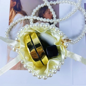 Internal view of handmade pearl bucket bag showing storage for makeup and accessories
