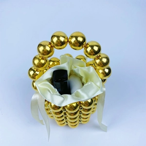 Top view of gold beaded bucket bag with white satin drawstring lining for cosmetics