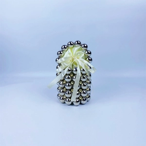 Detail of silver beaded handmade handbag with elegant white satin ribbon bow accent