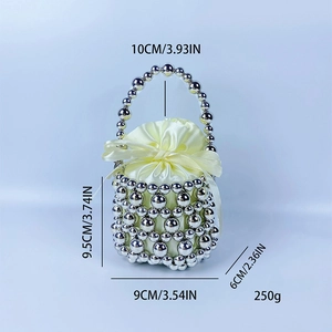Detail of silver beaded mini bucket bag with yellow satin drawstring pouch and bow