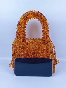Handmade amber beaded tote bag with stylish tassels and woven cat eye beads