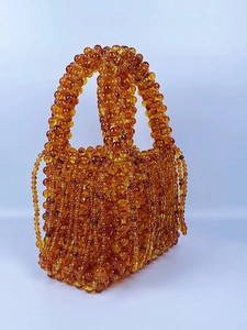 Handmade amber acrylic beaded handbag with woven hollow structure and fringe tassels