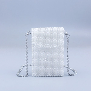 Detail of hand-woven white beaded phone bag featuring a silver metal chain and lobster clasps
