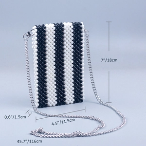 Detail view of handmade woven beaded crossbody bag with dimensions and silver chain strap