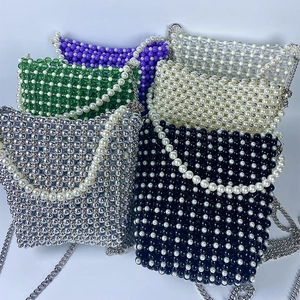 Collection of colorful handmade beaded mini crossbody bags with metallic chains