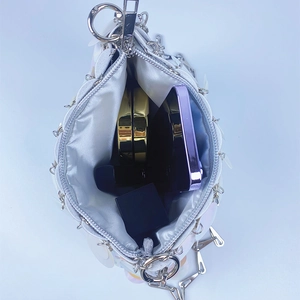 Internal view of a sequin bag showing capacity for phone, lipstick and compact powder