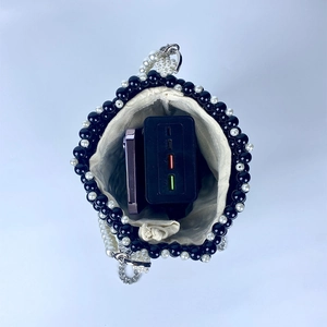 Interior view showing the storage capacity of the pearl beaded bucket bag with drawstring