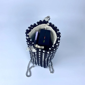 Top view of pearl beaded bucket bag showing interior space for phone and power bank