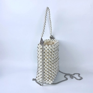 Detailed view of handmade white pearl woven bucket bag with drawstring liner and chain strap