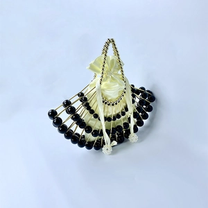 Detail of French vintage shell-shaped handbag with black beads and gold-tone metal frame