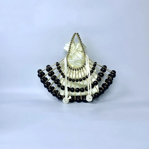 Detail of fan-shaped beaded handbag with gold frame and silk drawstring liner