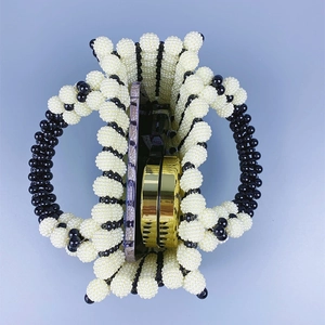 Top view of contrast pearl handbag showing interior space with phone and makeup box