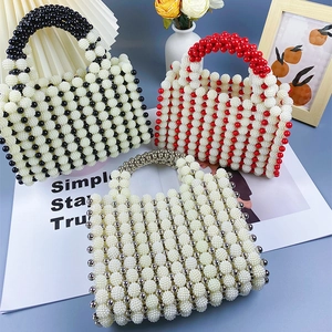 Detail of beaded evening bags featuring contrast patterns and elegant round handles