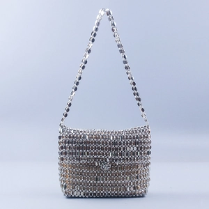 Detail of silver metallic sequin evening bag featuring a high-gloss woven texture