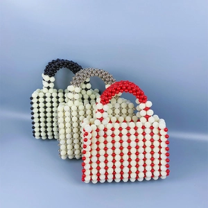 Detailed view of handmade woven pearl bead handbags in three elegant color combinations