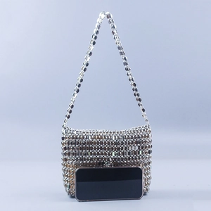 Detail of silver metallic sequin chain bag with brown lining and mesh structure