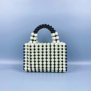 Close-up of contrast bead handbag featuring black and white woven pattern
