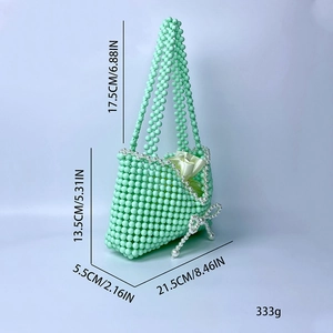 Detail of green beaded handbag with bow showing 21.5x13.5x5.5cm dimensions and weight