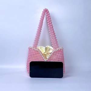 Pink handmade beaded mini bag with pearl trim and yellow satin drawstring inner pouch