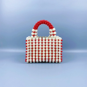 Detail of red and white handmade pearl beaded handbag with striped pattern and top handle