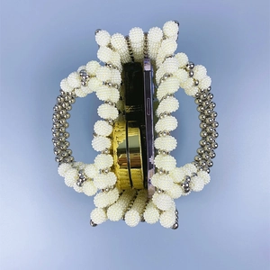 Top view of handmade pearl beaded handbag showing storage for phone and lipstick