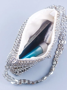 Chic silver beaded woven shoulder bag for evenings showing interior storage for smartphones