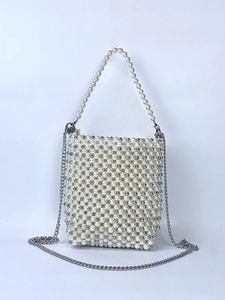 Elegant pearl beaded mini handbag with silver chain strap for women on blue background