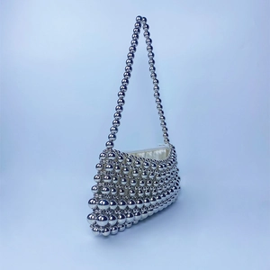 Detail of silver beaded handbag showing lustrous texture and satin lining detail