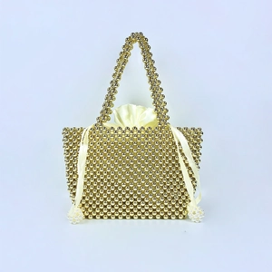 Detail of handmade gold beaded handbag with cream satin drawstring lining and pearls