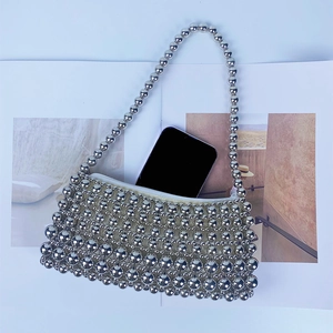 Detailed interior of silver beaded handbag showing capacity for a smartphone