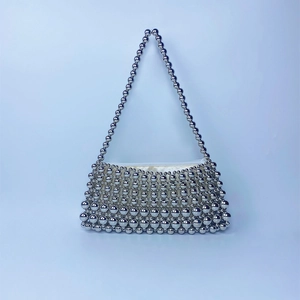 Detail of silver beaded handbag showing textured metallic beads and top zipper closure
