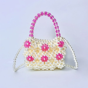 Detail of beaded handbag featuring pink 3D acrylic flowers and pearl woven texture