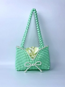 Handmade mint green beaded handbag with white bow detail and satin drawstring liner