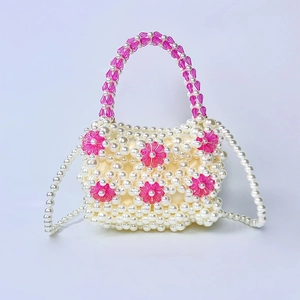 Detail of handmade beaded pearl mini bag featuring pink acrylic floral patterns and strap