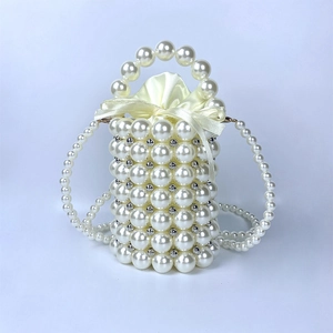 Detailed view of handmade pearl cylinder bag with satin drawstring liner and pearl strap