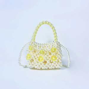 Detail of handmade pearl beaded handbag with yellow acrylic flower charms and strap