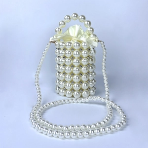 Detailed view of handmade pearl beaded bucket bag with champagne satin drawstring lining