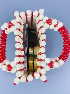 Handmade pearl beaded handbag with red accents showing interior capacity for phone and mirror
