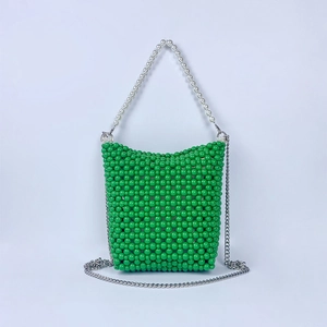 Detail of green beaded bucket bag featuring pearl top handle and silver metal chain strap