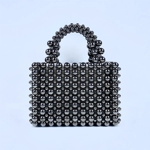 Front detail of handmade metallic grey beaded handbag with shiny woven texture