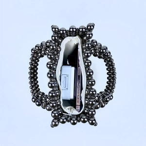 Internal view of handmade beaded bag showing storage capacity for phone and accessories