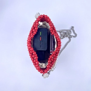 Top view of red beaded bucket bag interior showing beige drawstring liner and storage space