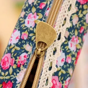 Floral canvas pencil case with navy rose pattern and vintage lace zipper detail