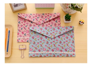 Detail of floral canvas A4 document bags with lace trim and metal snap button closure