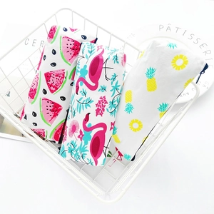 Canvas pencil cases with watermelon flamingo and pineapple prints in a white basket